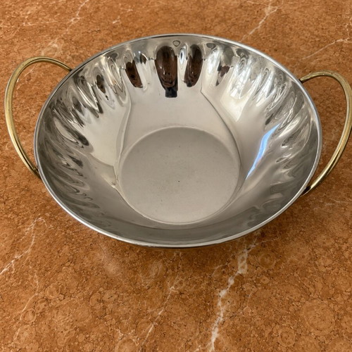 Metal serving bowl with gold handles