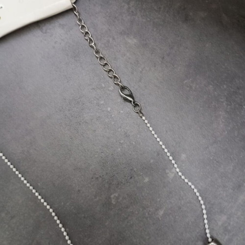 Necklace with white and silver beads and flower pendant