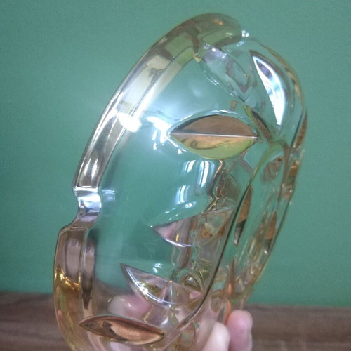 Crystal ashtray used, heavy with embossed gold-plated designs