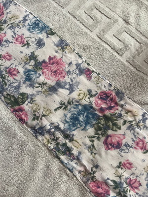 Bath towel used, light blue with printed fabric border