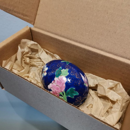 Porcelain egg used with hand-painted flowers and decorative butterflies