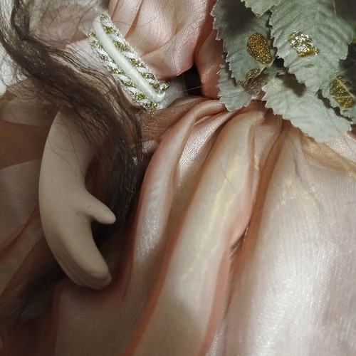 Porcelain doll sitting pose