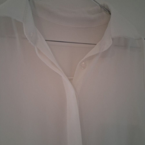 Sleeveless white shirt top