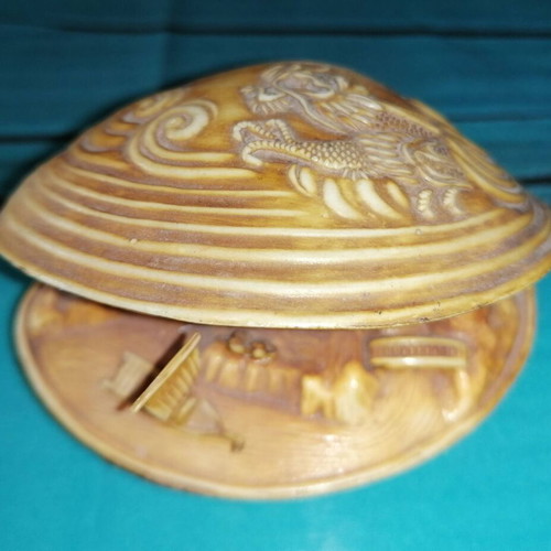 Vintage carved shell with dragon and scenic details