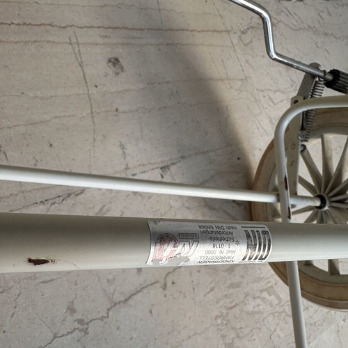 Vintage baby stroller with classic check fabric and metal frame