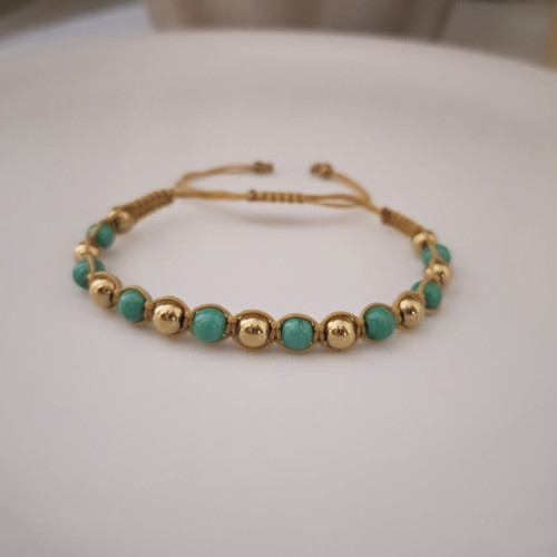 Handmade macrame bracelet with green and gold beads, adjustable