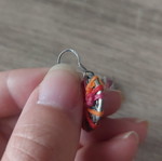 Silver earrings with multicolored waxed thread used