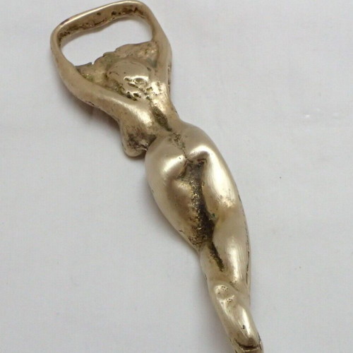Vintage brass bottle opener shaped like a woman used