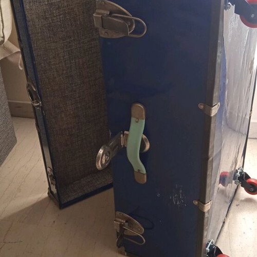 Vintage trunk table refurbished with leather handle and wheels