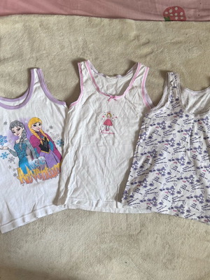 Pack of three used tank tops for 4-year-old girls, white and colorful