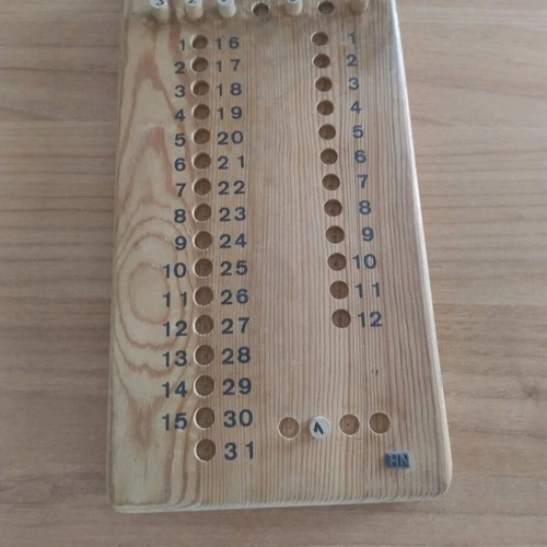 Vintage wooden calendar with pegs