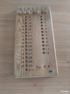 Vintage wooden calendar with pegs