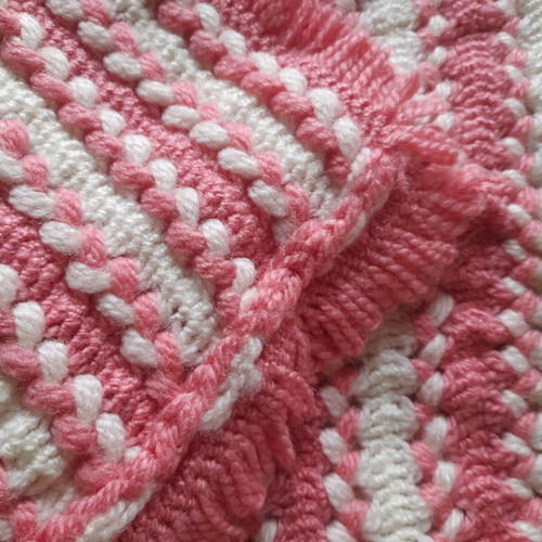Knitted handmade crib blanket used pink white