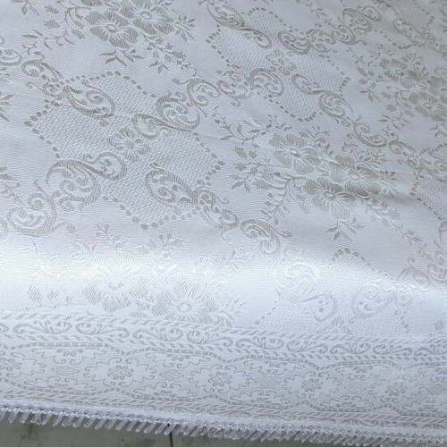 Woven quilt or throw with floral motifs, white