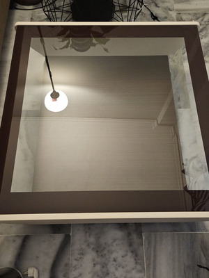 Coffee table used with glass top and storage space, brown and beige