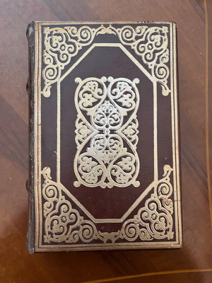 Leather box shaped like a book used with inner lining