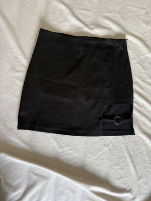 Mini black skirt with left hem detail