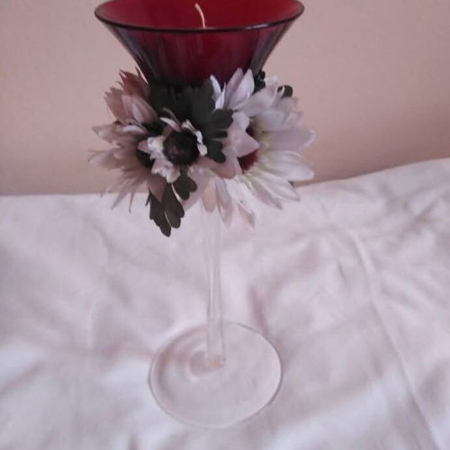 Glass candlestick used with floral wreath and burgundy candle