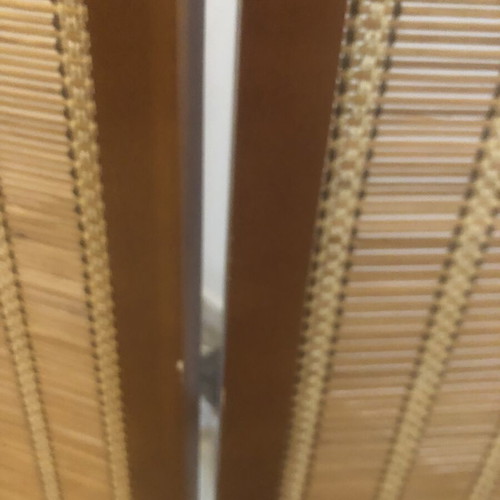 Brown bamboo room divider with slight wear