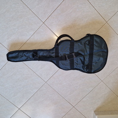 Classical guitar used with case, missing one string and small hole