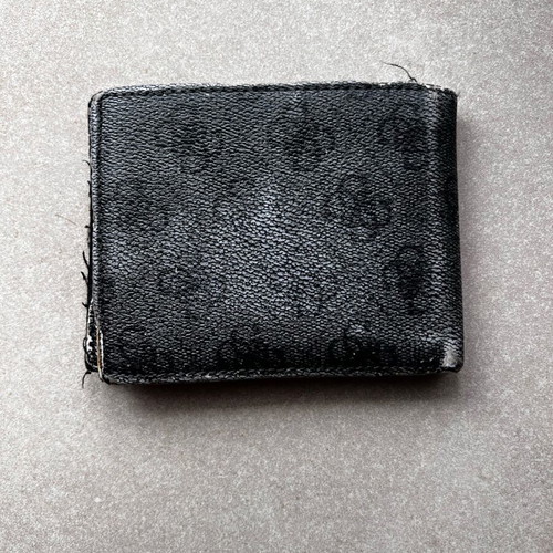 Guess wallet used with visible wear, black