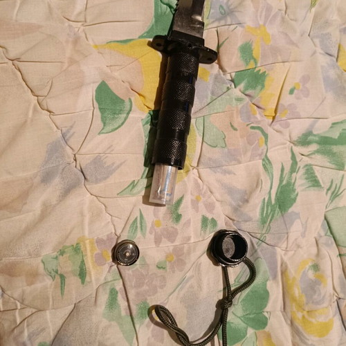 Survival knife used with needles, threads and compass