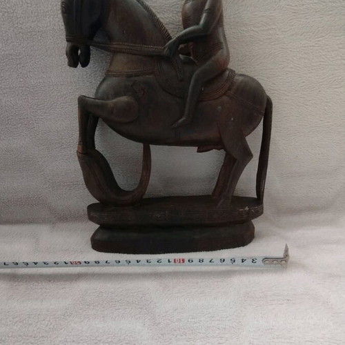 Wooden carving of South Indian man riding horse used