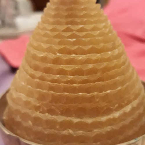Solid brass candlestick with beeswax candle used