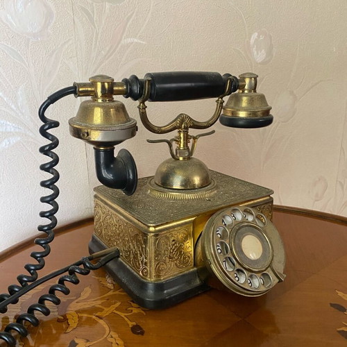 Vintage brass telephone used with embossed designs