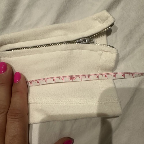 White elastic slim fit pants with ankle zippers