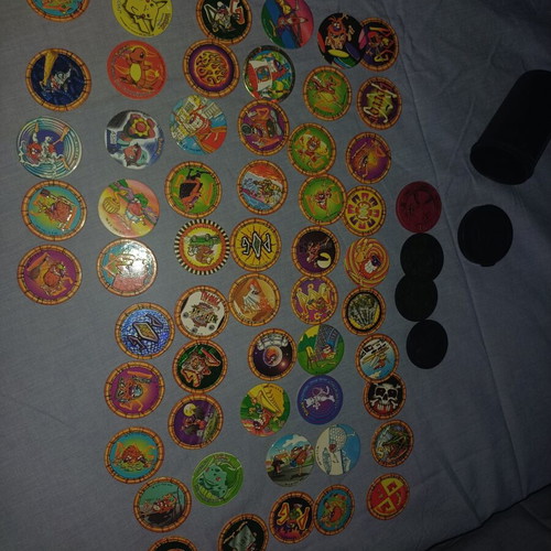 Vintage Pogs collection with Pokemon and Looney Tunes