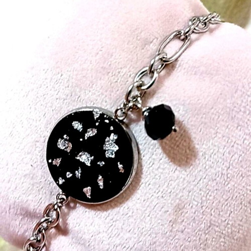 Handmade steel bracelet with iridescent black motif and silver flakes