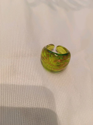 Glass ring unused, green with gold