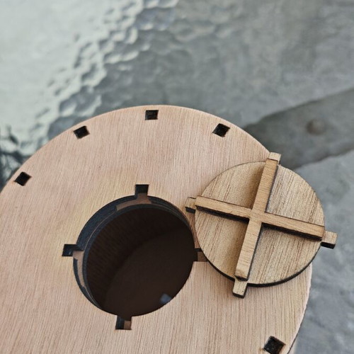 Handmade wooden laser-cut piggy bank with mechanical design