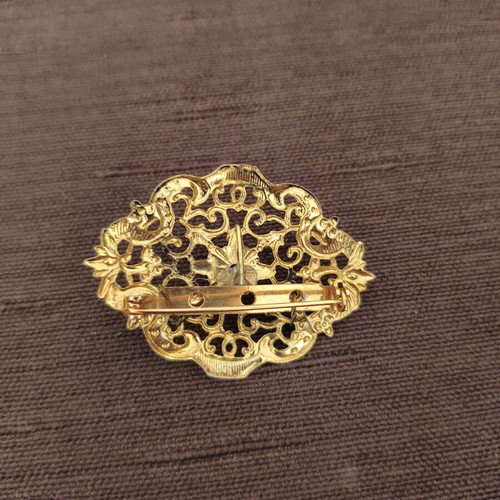 Vintage brooch with intricate filigree design and black stone like new