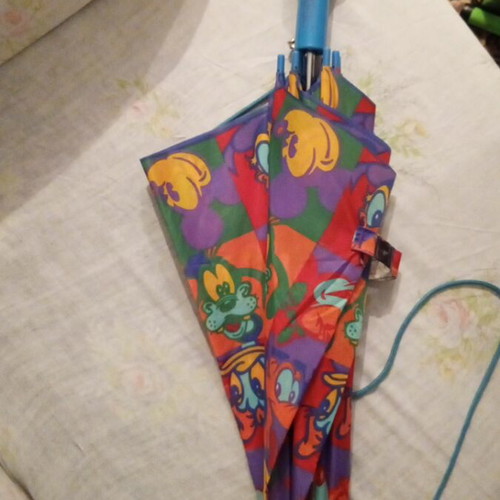 Disney umbrella used with blue Mickey Mouse handle, multicolored