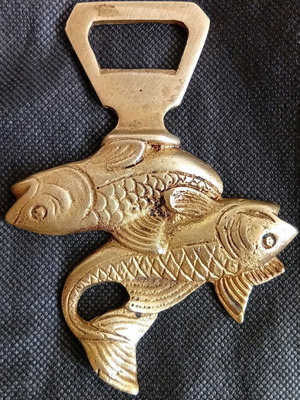 Vintage brass bottle opener used with Pisces fish design