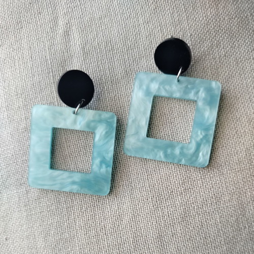 Statement earrings with aquamarine swirl resin square and black round base