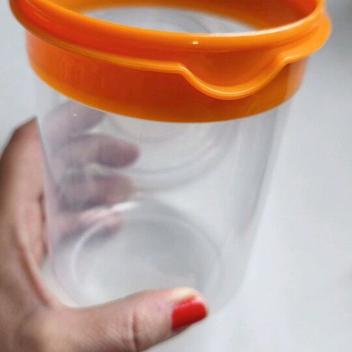 Storage container round like new, transparent with orange lid