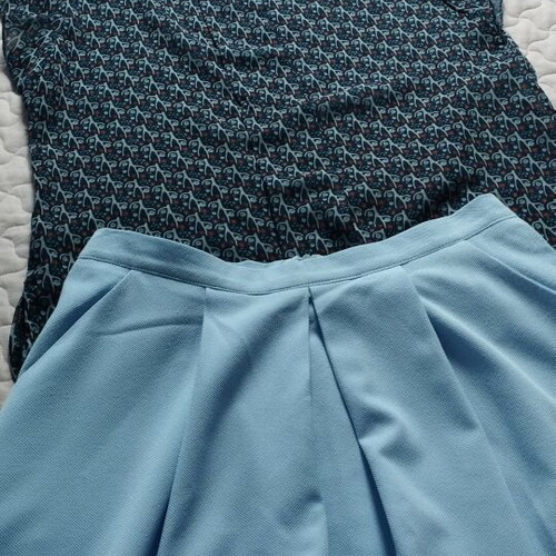 Set like new with blue knee-length skirt and semi-transparent top with ruffles