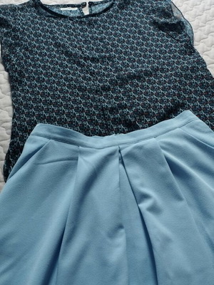 Set like new with blue knee-length skirt and semi-transparent top with ruffles