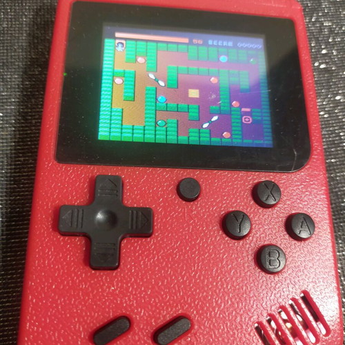 Retro style handheld game console used, working