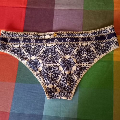Sugarfree swim brief with white-blue ethnic pattern, size Large, plus free black swim brief