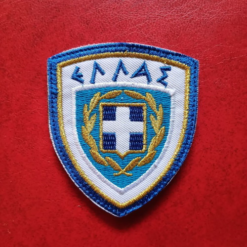 Collectible military uniform badge with national emblem, like new