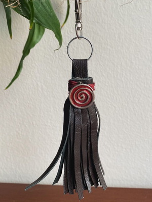 Handmade leather keychain with tassels and silver detail