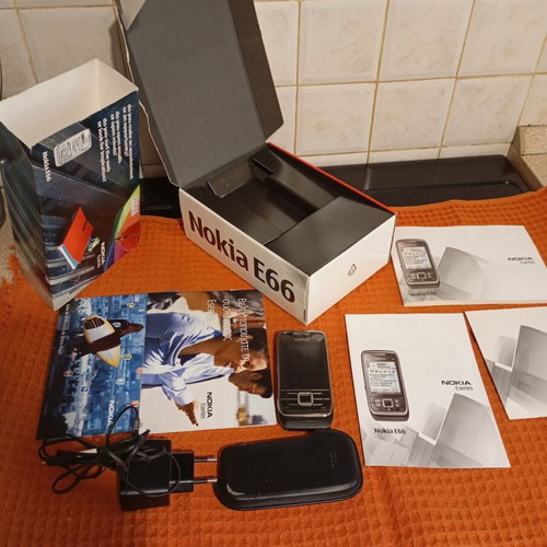 Nokia E66 retro slider phone used with original accessories