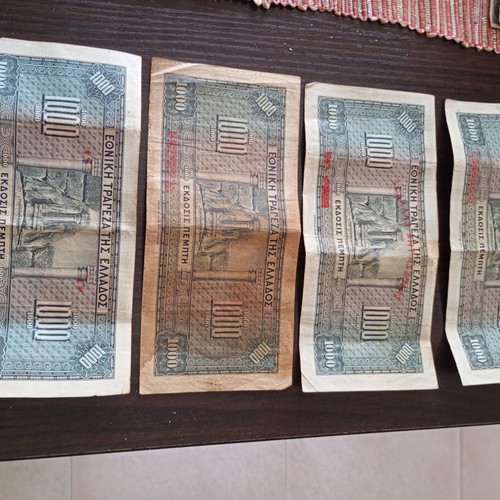 Old collectible banknotes used, 7 of 1000 drachmas and 4 of 500 drachmas