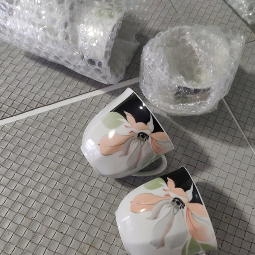 Set of cups and jugs used with lids and saucers