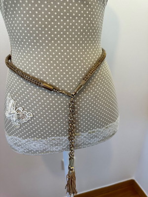 Accesorize beige belt with gold medium size and adjustable loop used