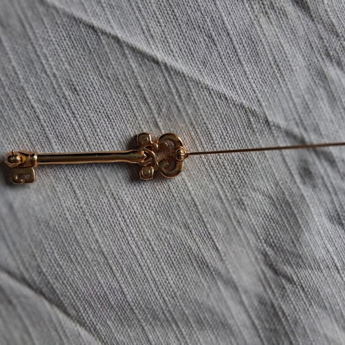Metal key-shaped pin like new, multicolored, gold tone